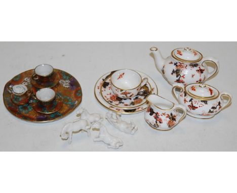 A miniature Coalport six piece tea service in the Hong Kong pattern, together with another miniature part tea service, and fo