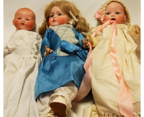 An Armand Marseilles 351 bisque head and composition baby doll together with one other larger example and a Simon & Halbig 11