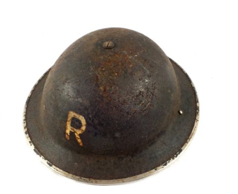 A tin helmet marked (R)