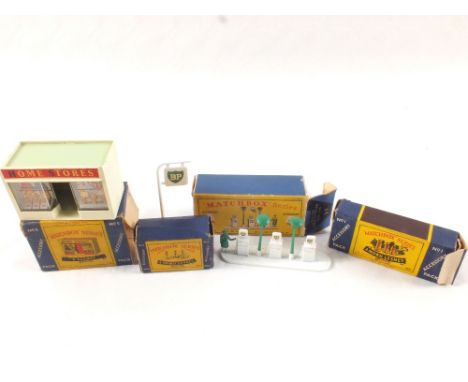 A boxed Matchbox accessories A1 petrol pump BP and No.1 Esso, No.4 road sign set, No.5 Home Stores shop (missing end flaps)