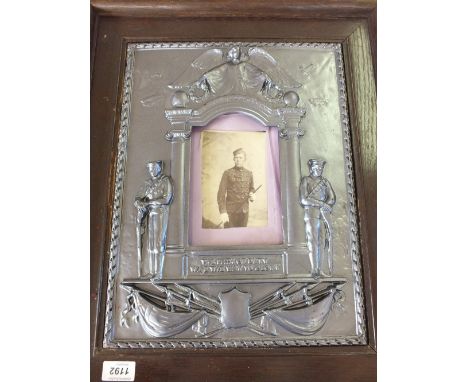 WWI Casualty memorial frame with selection of group and portrait photos, some in frames