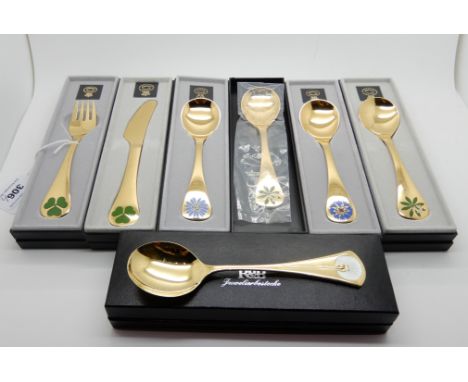 A lot comprising four cased Georg Jensen sterling silver gilt Christmas spoons, a fork and a knife, also a sterling silver gi
