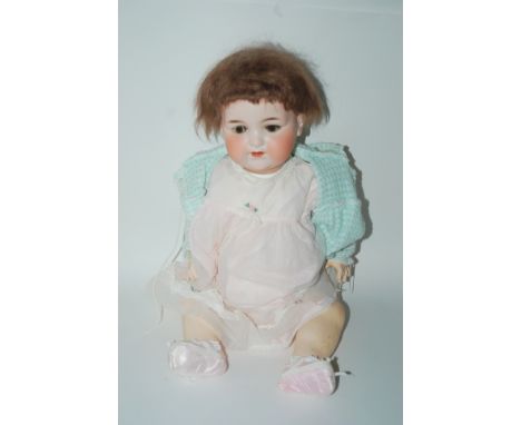 A large Armand Marseille 990 bisque-headed doll with open and close brown eyes, open mouth and painted features with impresse