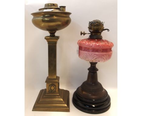 A cranberry milk glass oil lamp and brass oil lamp, both lacking shades and another (3) Condition Report: no damage to cranbe