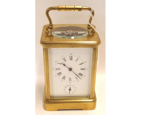A French brass and glass carriage clock with inscription reading "presented to Mr R H Edwards in recognition of his services 