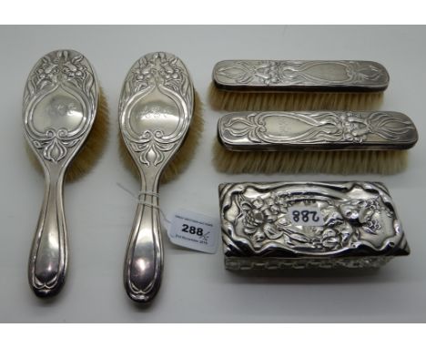A lot comprising a four piece silver backed dressing table set, London 1914 and a silver topped trinket dish, Birmingham 1911