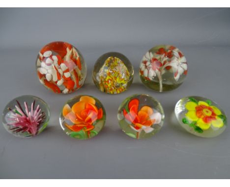 Seven vintage paperweights with floral type inclusion