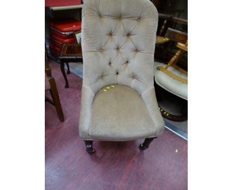 Button upholstered spoonback chair on brass castors