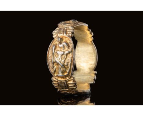 Ca. AD 1400 .A finger ring with four oval bezels integrated into the band. One depicts a pair of hands with elongated fingers