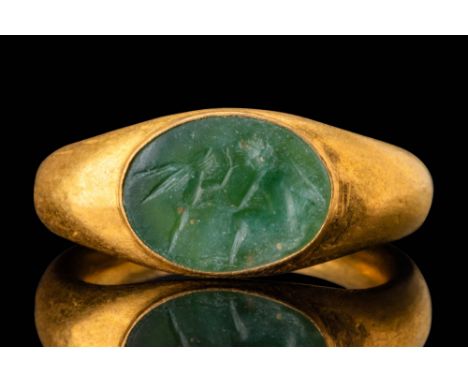 Ca. AD 200 - 400. An oval green intaglio engraved with two winged Erotes facing each other, one seated on the right and the o