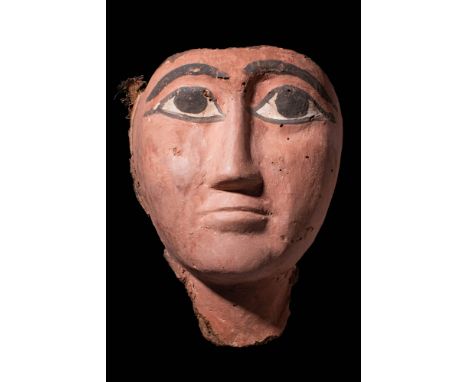 Late Period, Ca. 664 - 332 BC.A polychrome wooden coffin mask with a broad face painted in a reddish hue. The eyes are large 