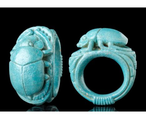 Late Period, Ca. 664 - 332 BC.A faience ring with a bezel in the form of a scarab. Its back is divided by a central ridge sep