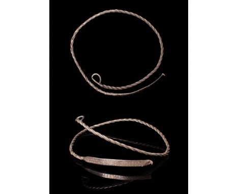 Ca. AD 800 - 1100.A torque crafted from a silver wire twisted into a helical form. One end concludes in a small, rounded loop