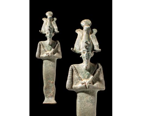 Late Period, Ca. 664 - 332 BC.A cast bronze statuette of Osiris depicted mummiform, with silver inlaid eyes, standing with ar