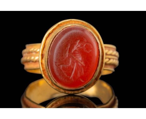 Ca. AD 300 - 500. An oval carnelian intaglio engraved with a standing eagle grasping a wreath in its beak. The body displays 