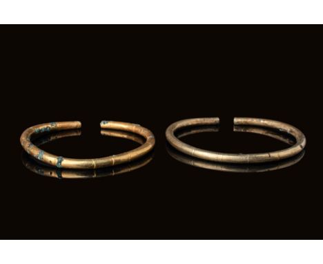 Ca. 600 - 500 BC. A pair of gold bracelets shaped into a circular form with a small opening at the ends. Both bracelets are d