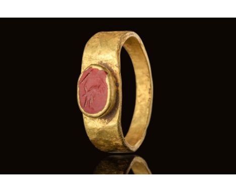 Ca. AD 50 - 200.A red jasper intaglio engraved with a bird in profile. The body is defined by shallow incisions outlining the
