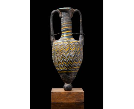 Ca. 200 - 1 BC.A core-formed glass amphoriskos with an inverted piriform body tapering to a rounded knob at the base. Two ver