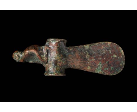 Ca. 1200 - 800 BC. A bronze axe head with an elongated, flattened blade ended in a rounded cutting edge. The tubular shaft is