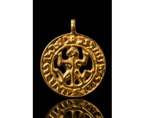 Ca. AD 900. A gold pendant with an openwork design featuring a central stylized frog within a circular border. The outer rim 