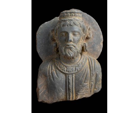 Ca. AD 200 - 400, or later. A schist relief of a Buddhist monk, dressed in monastic robes. Comes with a custom made stand.Siz