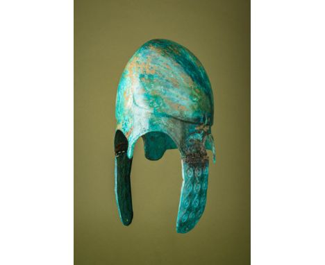 Ca. 500 BC.A bronze Chalcidian helmet with a rounded skull and a high carinated crown. A raised ridge runs along the lower ed