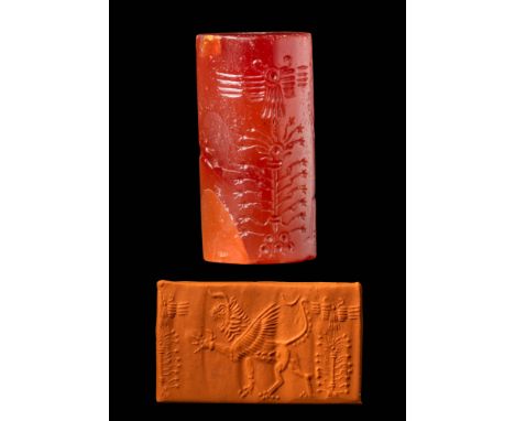 Ca. 1200 - 800 BC. A reddish stone cylinder seal with a roaring lion-like mythical creature and a life tree, above which luna