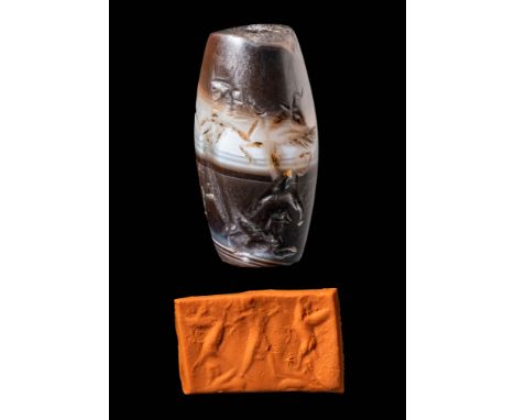 Ca. 8th - 6th century BC. A barrel-shaped banded agate seal depicting a royal or divine hero battling mythical creatures. Stu