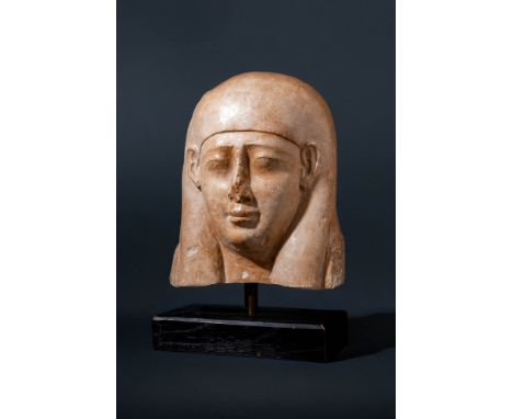 Ptolemaic Period, Ca. 332 - 30 BC. An upper part of limestone model coffin. The face with a rounded jawline, smooth cheeks, a