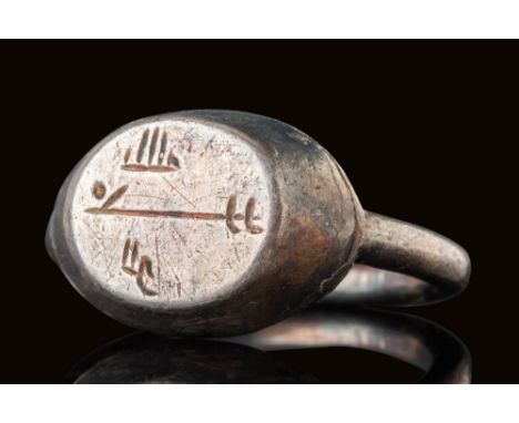 Ca. AD 700 - 1000.A silver ring with a raised, flat bezel engraved with three lines of Arabic inscription in Kufic script. Th