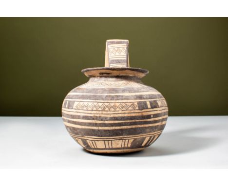 Ca. 550 - 450 BC.A terracotta jug with a rounded body, a wide flaring mouth, and a single vertical handle extending from the 
