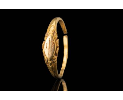 Ca. AD 600 - 900.A gold ring with an elongated, almond-shaped bezel engraved with an ankusha symbol, a stylised representatio