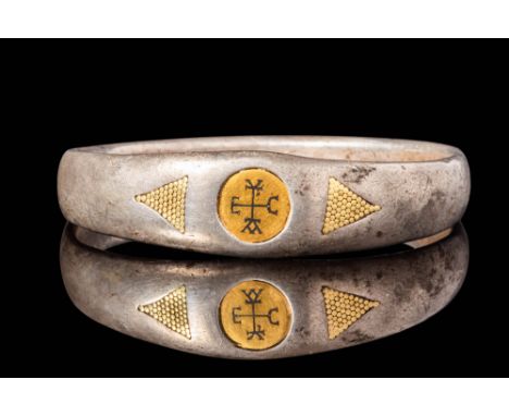 Ca. AD 800 - 1000. A silver bracelet with a slightly convex exterior and a smoothly rounded inner surface. The band widens at