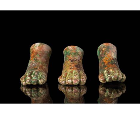 Ca. AD 1 - 300. A collection of three bronze votive offerings in the form of anatomically detailed feet. The toes are individ
