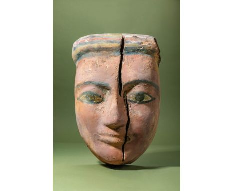 Late Period, Ca. 664-332 BC.A wooden mummy mask from the lid of an anthropoid coffin, coated in gesso and painted with polych