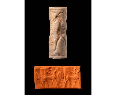 Ca. 13th - 12th century BC. A buff-coloured cylinder seal depicting a mythical creature and a life tree, with a lunar crescen