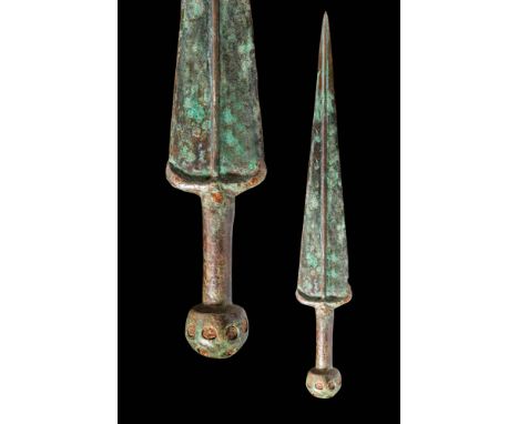 Ca. 900 - 700 BC.A bronze sword with a tapering blade and a reinforced midrib running along its length. The blade has straigh