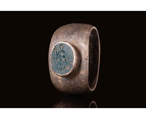 Ca. AD 100 - 200.A dark green jasper intaglio engraved with a standing female figure identified as the goddess Fortuna, swayi