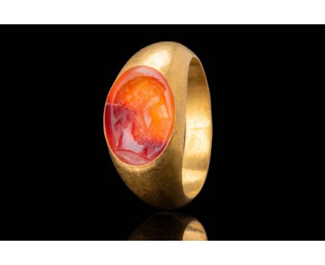 Ca. AD 100 - 300. An oval carnelian intaglio depicting Jupiter in profile facing right. The engraving shows a bearded male fi