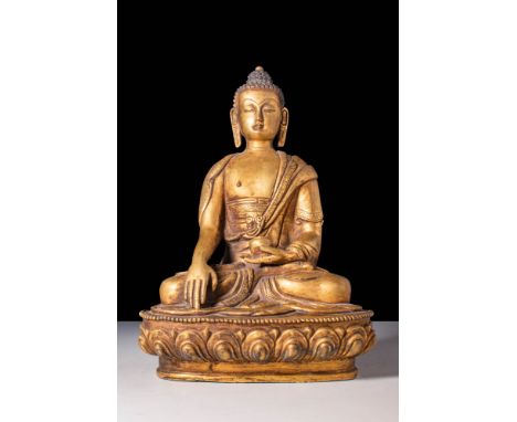 Ca. 19th Century AD.A gilded bronze Buddha, seated on a lotus base. The serene figure in bhumisparsha mudra holds an alms bow