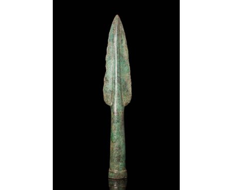 Ca. 1200 - 1000 BC. A bronze spearhead with a leaf-shaped blade tapering to a sharp point. The blade features a pronounced ce