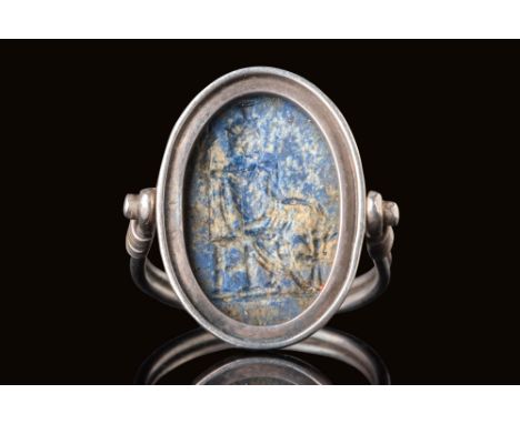 Ca. AD 100 - 200.A lapis lazuli intaglio depicting Serapis, set within a silver swivel ring. The intaglio is oval, engraved w