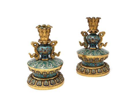 A pair of Chinese gilt-metal-mounted cloisonné candlesticks, Qianlong (1736-1795), each of a baluster vase set on top of a do