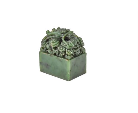 A Chinese spinach jade dragon seal, Qing Dynasty, surmounted by a craved dragon amidst clouds, the stone of spinach-green ton