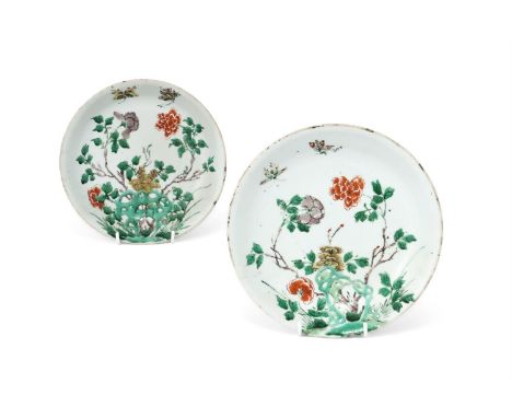 A pair of Chinese Famille Verte dishes, Kangxi, painted with peony issuing from rockwork and with butterflies above, 21.5cm d