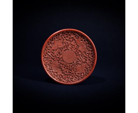 A Chinese carved cinnabar lacquer 'Lions' dish, 16th century, Ming Dynasty, the circular dish crisply carved through layers o