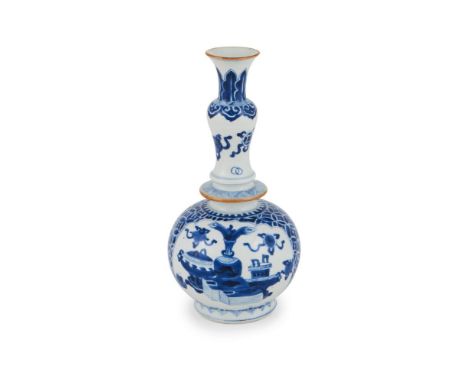 A Chinese blue and white vase, Kangxi, painted with baskets of flowers and precious objects, the neck of the vase modelled as