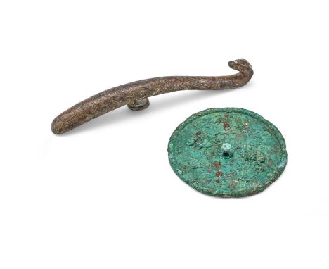 A Chinese silver inlaid belt hook, Warring States period, the arched shaft finely inlaid in silver with overlapping scrolls, 