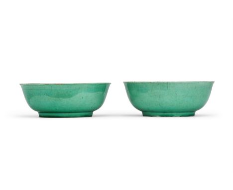 A pair of Chinese green-glazed bowls, Kangxi mark and of the Period, each with rounded sides rising from a short foot to a ge