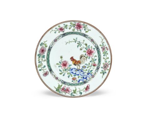 A Chinese Famille Rose 'Cockerel' plate, Yongzheng or early Qianlong, the cockerel perched on openwork rock surrounded by flo